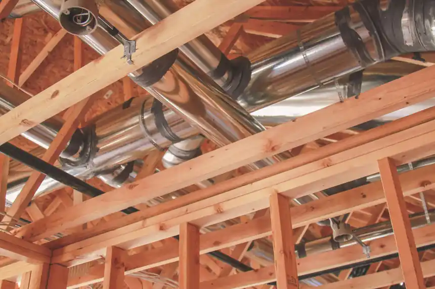 Duct trunk line running through the framing of a house