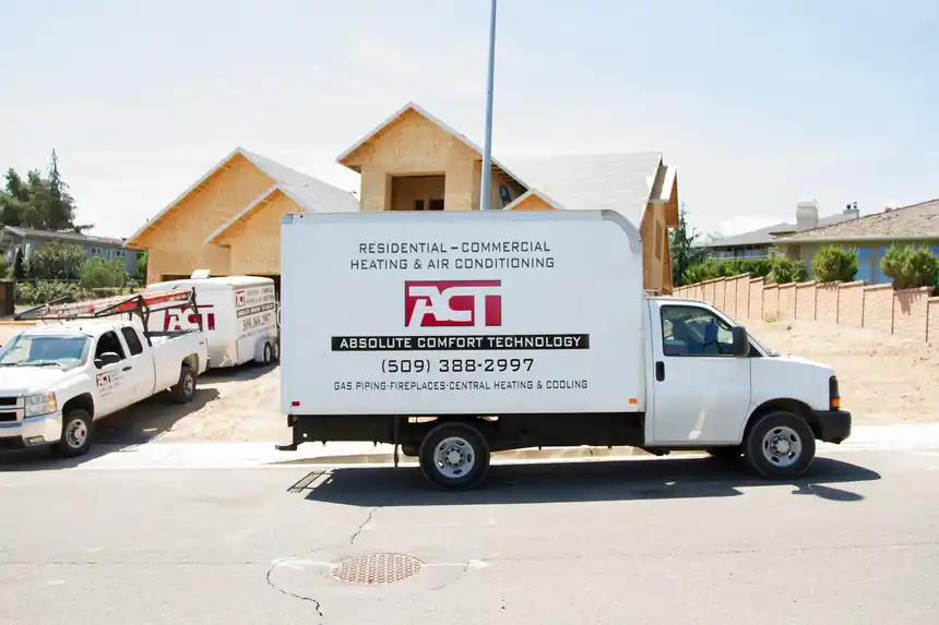 ACT box truck parked in front of a framed new home under construction
