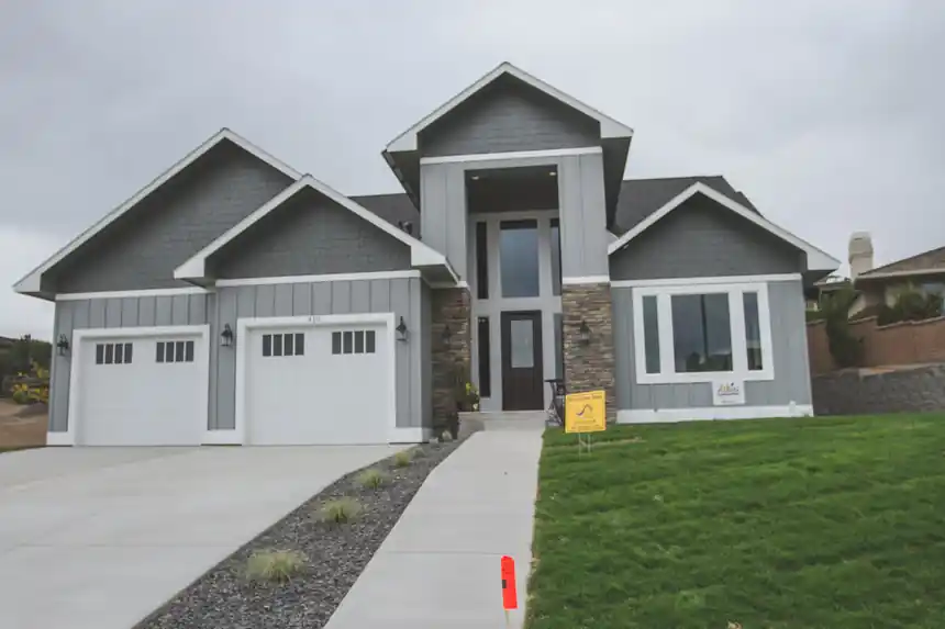 A finished grey craftsman home, one of ACT's new-construction jobs