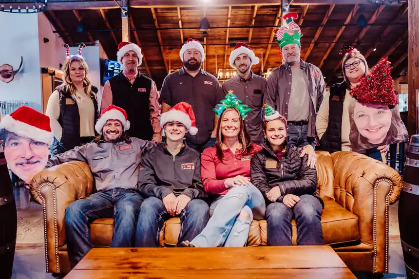 The ACT team gathered in Santa hats for the 2023 holiday photo
