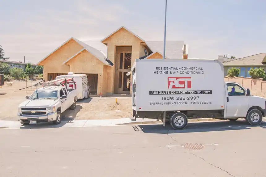 An ACT pickup and box truck at a house under construction