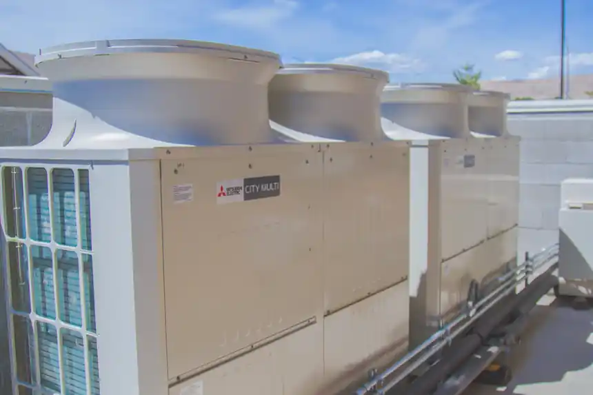 Row of Mitsubishi CITY MULTI VRF condensers installed on a rooftop